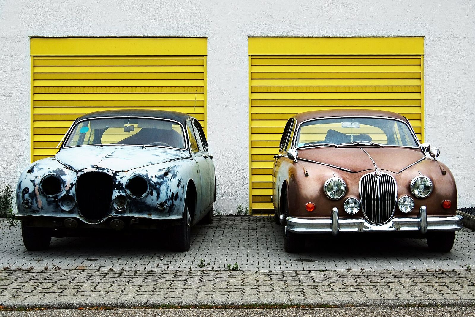 Two classic saloons, one with tired paint and one restored