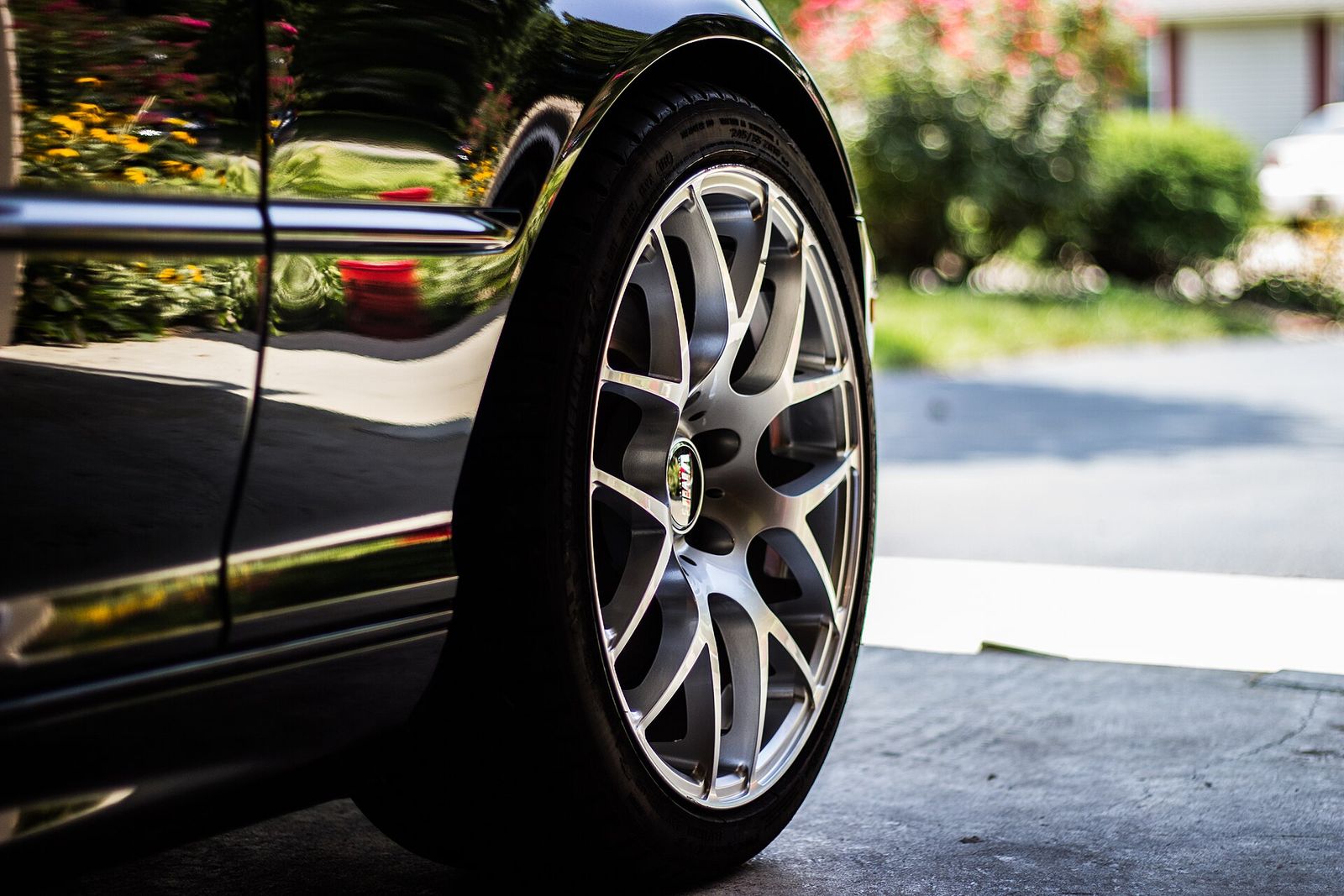 A clean alloy wheel against black paint
